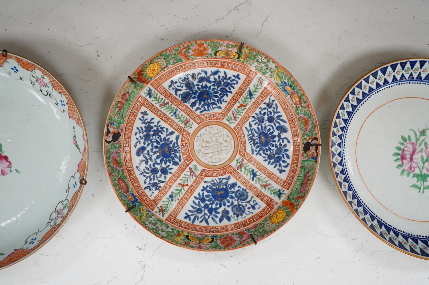 A Chinese enamelled floral porcelain dish made for the Persian market, c.1905 and two other Chinese plates, 28cm diameter. Condition - good, one dish sounds dull